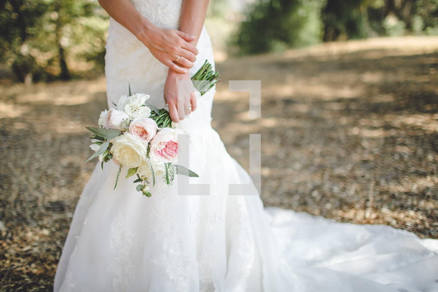 Bride's hands holding a bouquet.