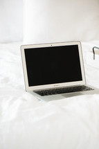laptop computer on a bed 