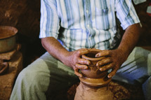 a man at a potters wheel 