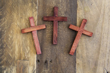 three wooden cross on a wood floor 