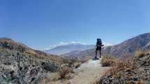 person hiking a desert mountain trail 