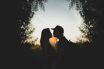 silhouette of a kissing couple 