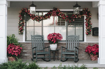 A porch with rocking chairs decorated for Christmas.