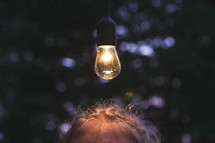 a light bulb over a woman's head