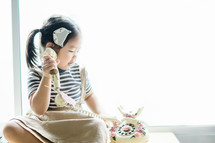 a little girl talking on a vintage phone 