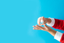 a child using spray on hand sanitizer 