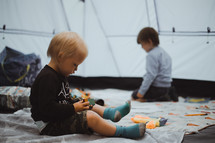 boys playing with toys in a tent 