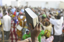 A Bible is held up high during a praise and worship service in Africa