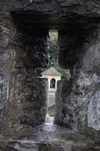 cross window cut into stone 