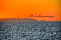 distant Catalina Island under an orange sky 