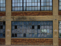Abandoned brick and cement building with broken windows 
