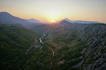 aerial view over mountains and valley at sunset 