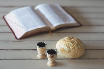 open Bible and communion bread and wine 