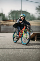 child riding a bike at a park 