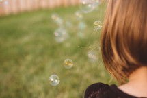 girl child blowing bubbles 
