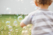 toddler playing with bubbles 