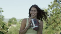 a young woman catching and throwing a football 