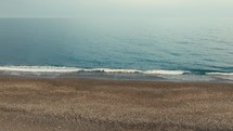 Relaxing calm ocean waves on sandy beach 