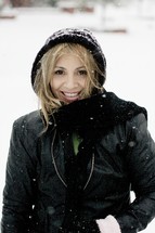 A woman smiling in the snow