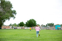 Little girl running to the playground 