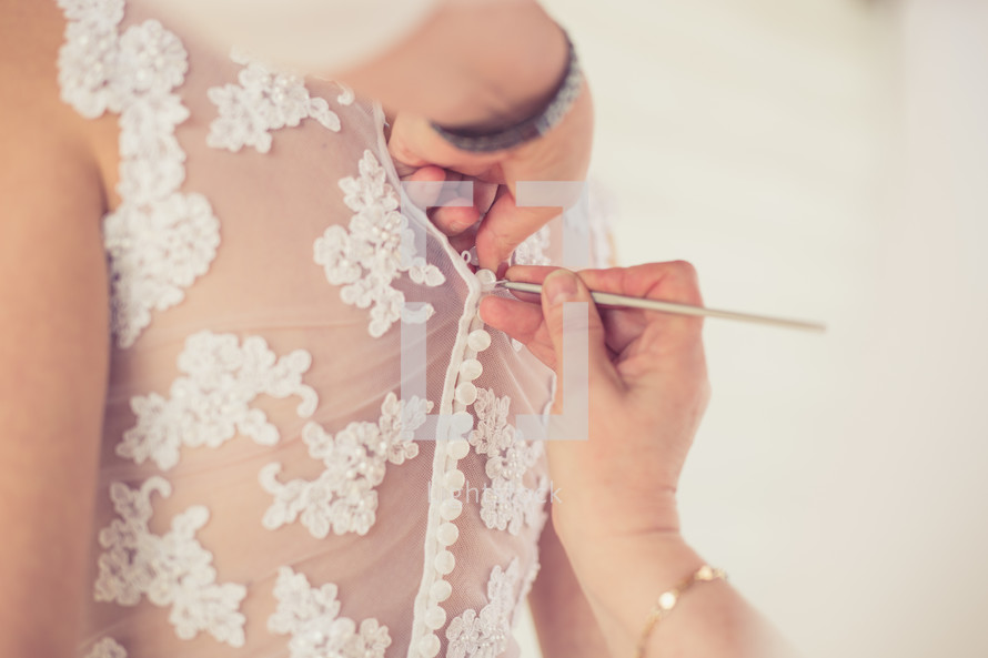 seamstress altering a wedding dress 