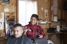 Man getting his hair cut by a barber.