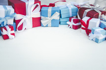 blue, red, and white wrapped Christmas gift boxes border on white 