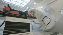 Patient Getting Radiation Therapy Treatment Inside A Modern Radiotherapy Room
