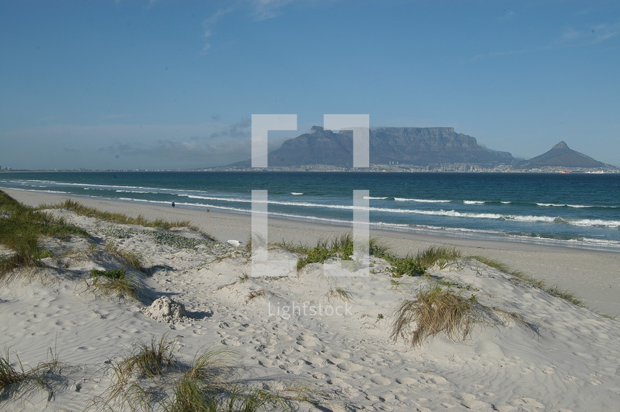 Dunes on a white sand beach in front of  Table Mountain