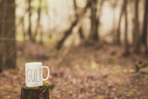 a mug on a tree stump 