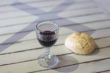 cross shadow and communion bread and wine 
