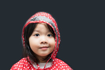 a little girl in a rain jacket 