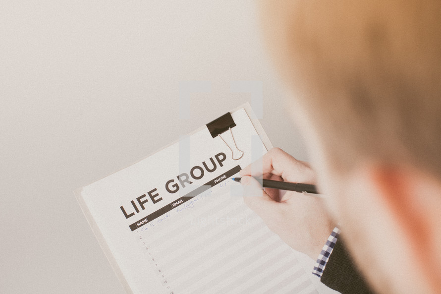 A man signing up to be in a life group 