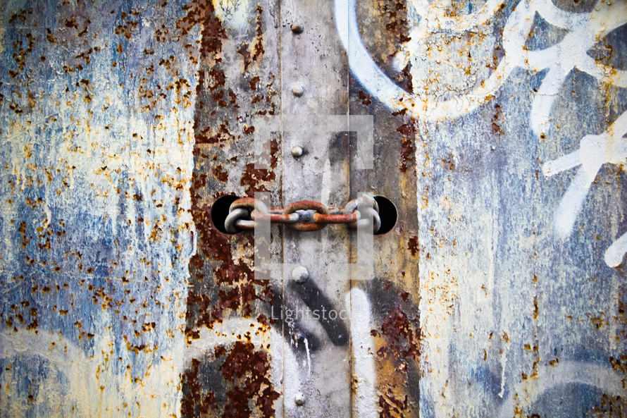 rusty chain and graffiti on metal 