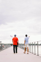 men walking on a pier 