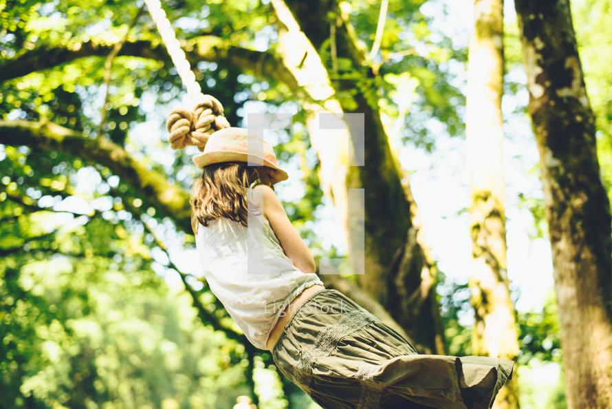 a girl on a rope swing 