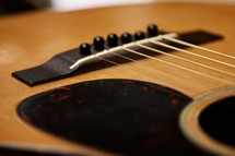 pick guard, bridge, and saddle of an acoustic guitar 