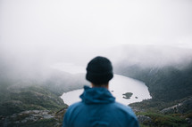 a man with a view of a lake in a valley in Tasmania 