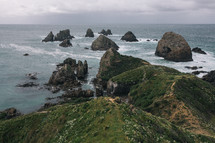 rock formations in the ocean along a shoreline in New Zealand 