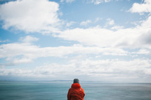 a woman taking in the views from a cliff in New Zealand 