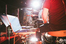 A drummer sitting among his instruments.
