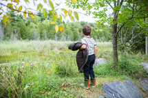 a boy exploring outdoors 