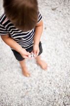 toddler playing in gravel 