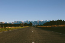 A highway leading to a mountain range.
