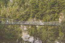 A pedestrian suspension bridge over a gorge.
