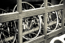 bikes wheels though a garage window 