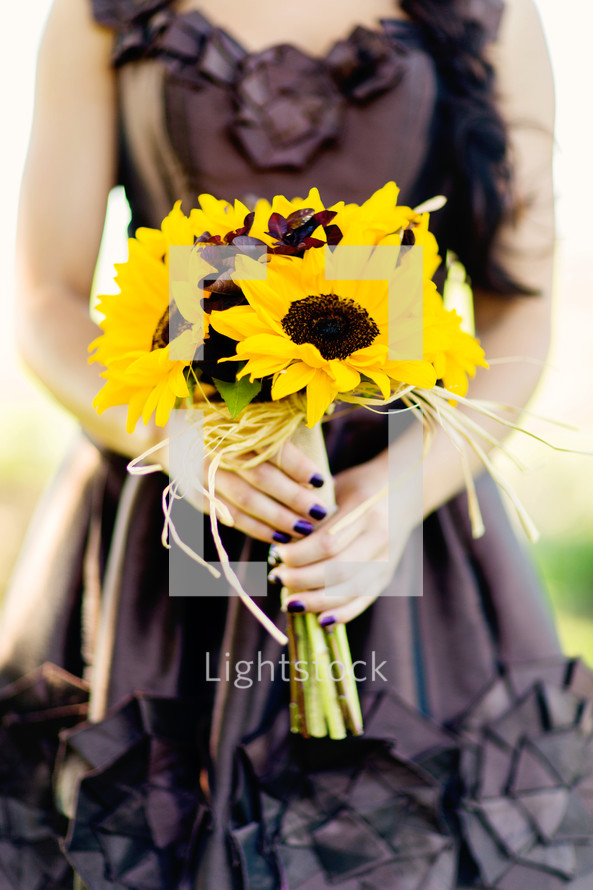 Woman holding sunflower bouquet