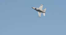 F-16 fighter planes flying at high speed during an airshow.