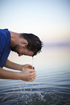 A man coming out of the baptismal waters