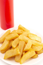 A Pile of Chunky Steak Fries Isolated on a White Background and ketchup 
